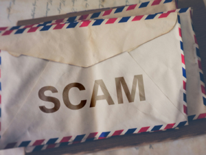 Official looking envelope with the word Scam on it